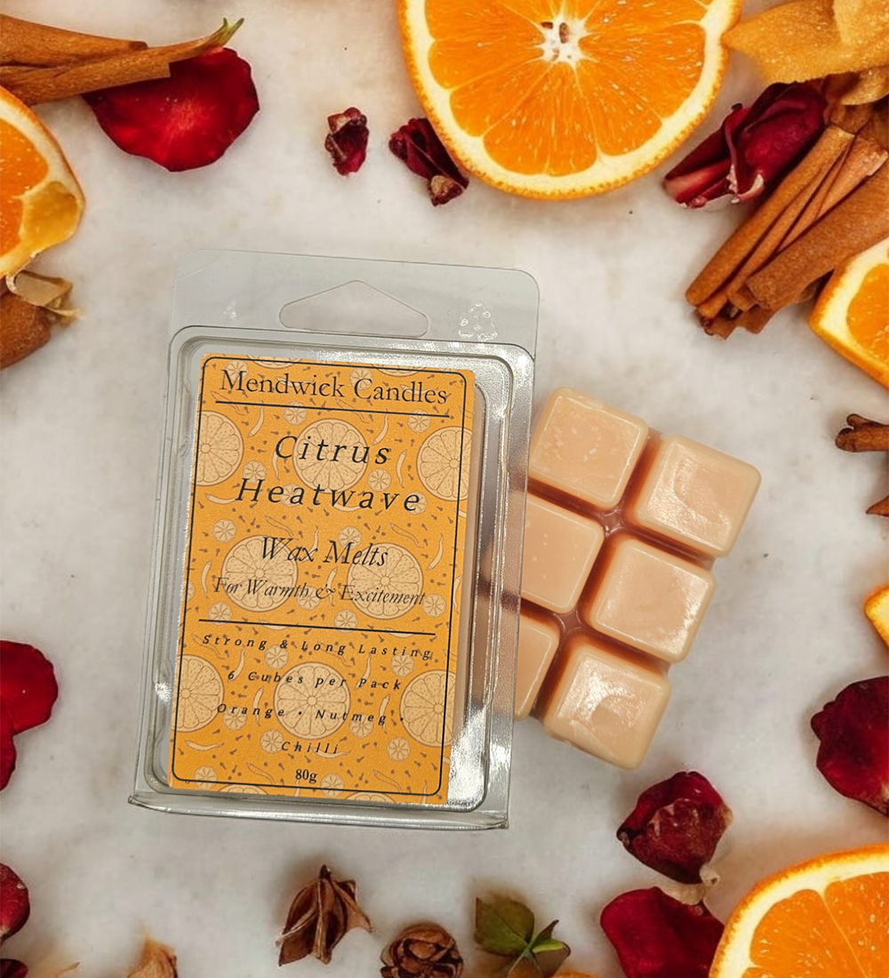 Citrus Heatwave Wax Melts surrounded by oranges, spices and chilies