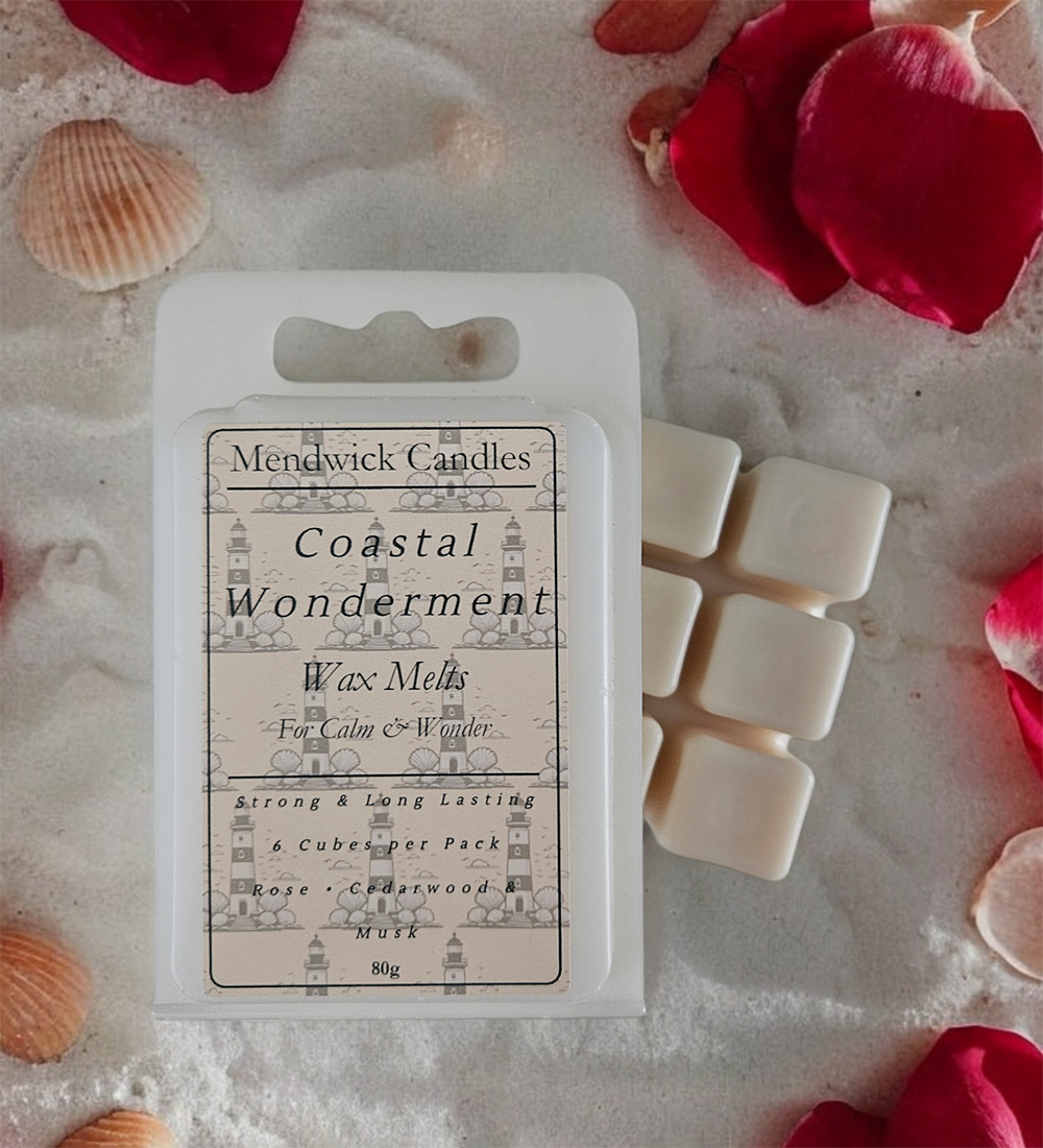 Costal Wonderment Scented Wax Melts shown on sand with pebbles and petals.