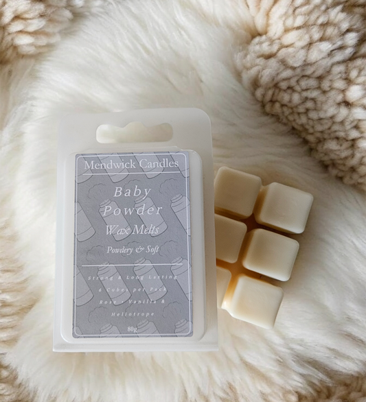 Baby Powder wax melts shown on a wool rug