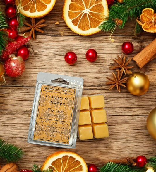 Cinnamon Orange Wax Melts - shown on a wooden board surrounded by orange slices and warm spices set in a festive theme