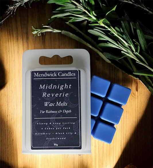 Midnight Reverie Wax Melts, shown on a wood board with rosemary