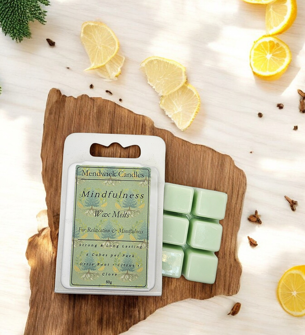 Mindfulness Wax Melts - Shown lay on a wooden board with citrus slices and cloves scattered around